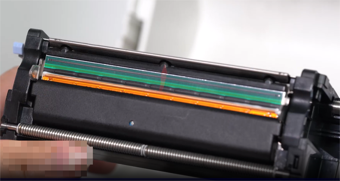 Um close-up of a person carefully cleaning an electronic component with a swab.